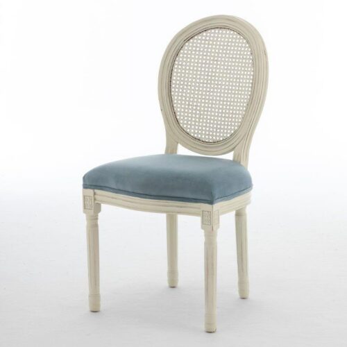 White cane-back chair with blue velvet seat.