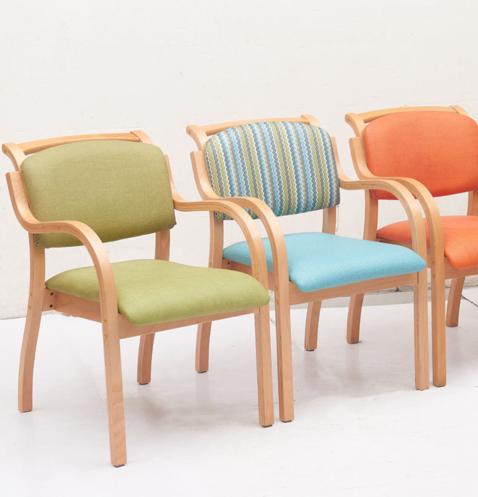 Three colorful fabric chairs with wooden frames.
