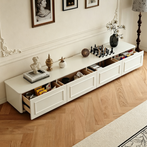 White long media console with open drawers and decorative items.