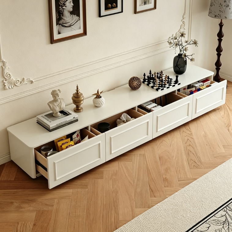 White long media console with open drawers and decorative items.