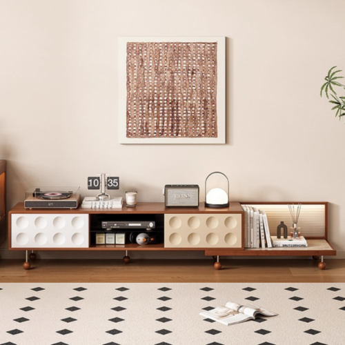 Modern wooden console table with circular cutouts and shelves.