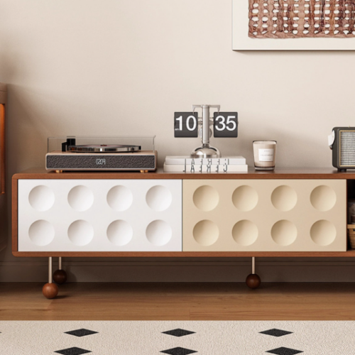 Modern wooden sideboard with circular cutouts and minimalist decor.
