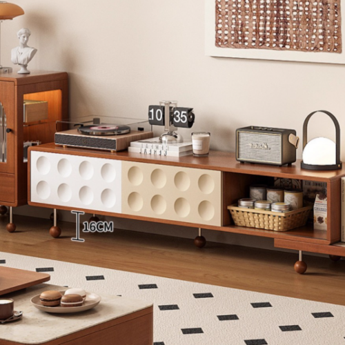Wooden TV console with round cutouts and storage shelves.