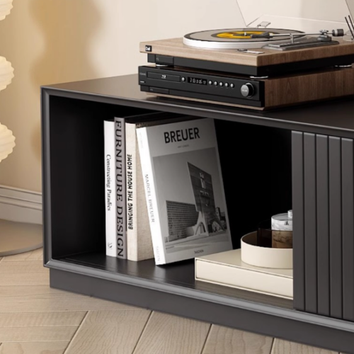 Modern black media console with vinyl player and books.