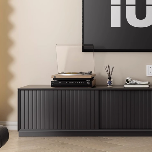Black modern console table with vinyl player and decor.