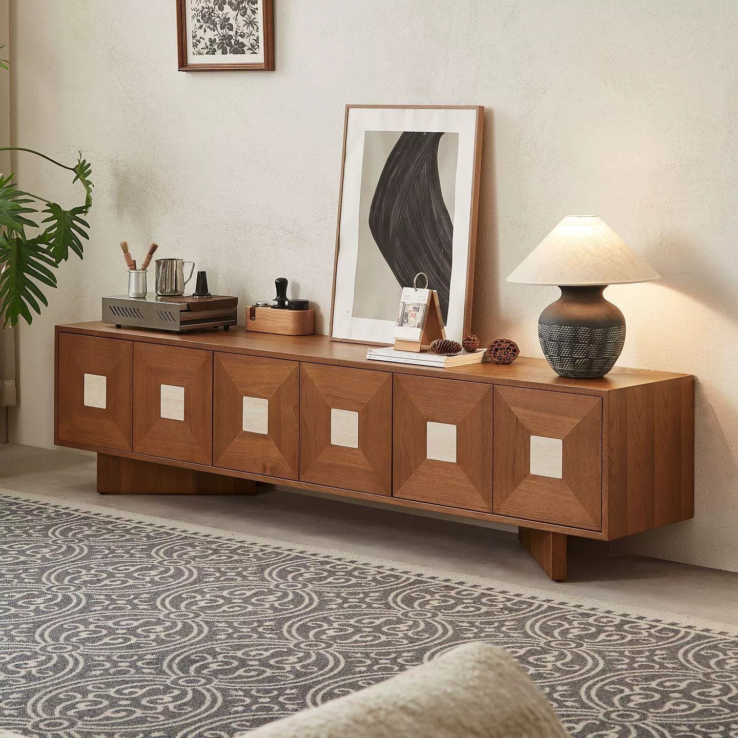 Wooden sideboard with geometric panels and decorative items.