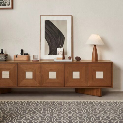 Wooden media console with geometric cabinet doors and modern decor.