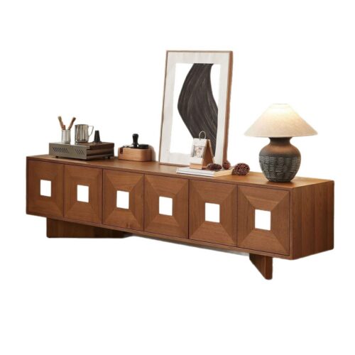 Wooden media console with square cutouts and decorative items.