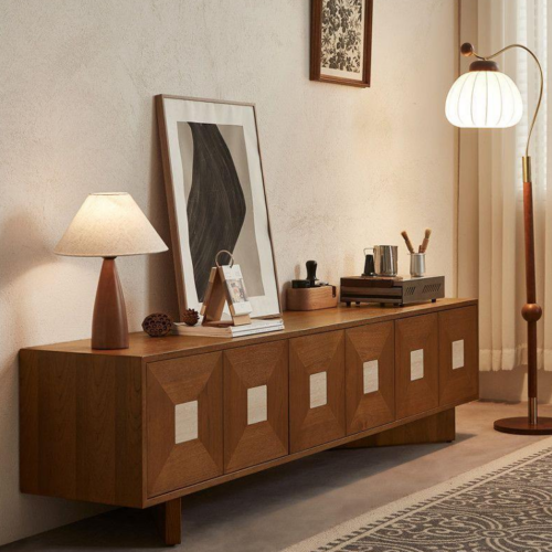 Wooden sideboard with geometric panels and warm lighting.