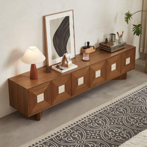Wooden sideboard with geometric cabinet doors and modern decor.