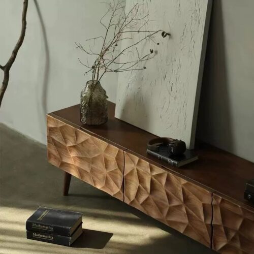 Geometric wood console table with vase and books.
