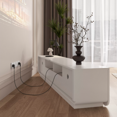 White console table with vase and cables on wooden floor.
