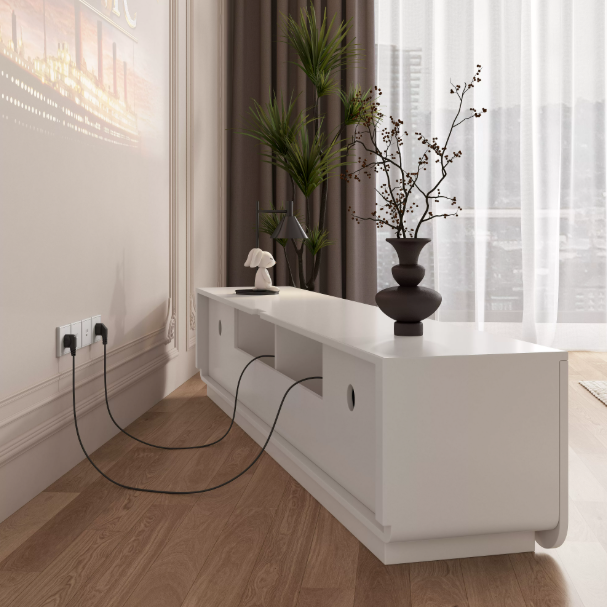 White console table with vase and cables on wooden floor.