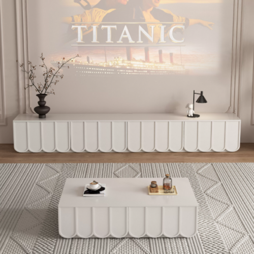 White modern TV console and matching coffee table with geometric design.
