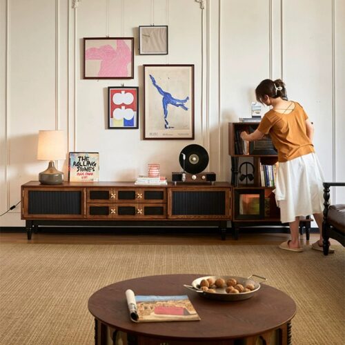 Wooden sideboard with black panels and drawers.