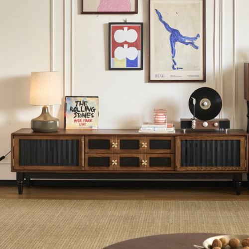 Wooden sideboard with black panels and decorative knobs.