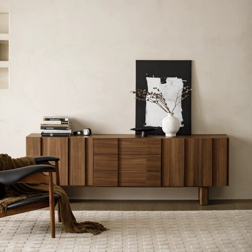 Wooden sideboard with modern design and decorative items.
