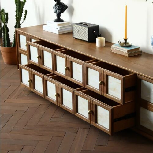 Wooden storage cabinet with glass panels and brass knobs.