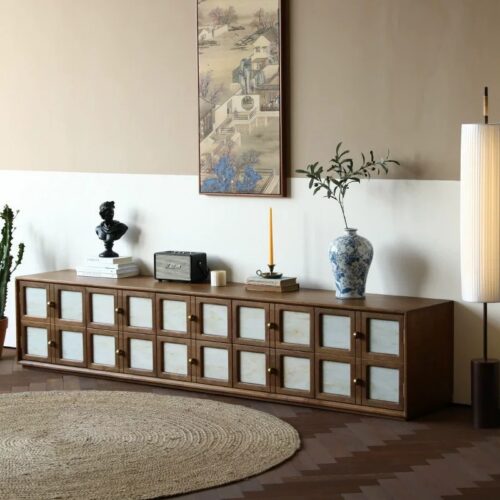 Long wooden cabinet with frosted glass doors in modern living room.