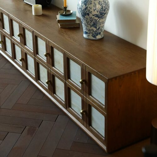 Wooden console table with glass-front drawers.