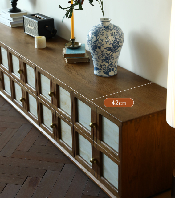 Wooden cabinet with glass panels and brass knobs.