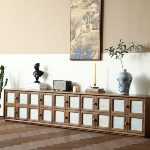 Wooden cabinet with glass doors displayed in a styled room.
