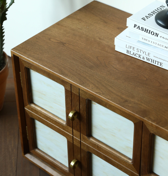 Wooden cabinet with glass panels and brass handles.