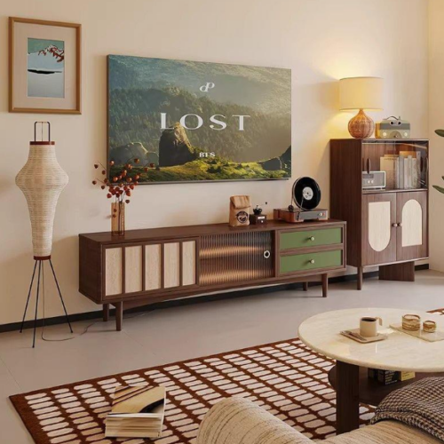 Wooden TV console with green drawers and side cabinet.