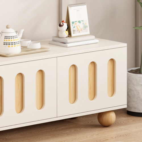 White cabinet with wooden slots and round legs.