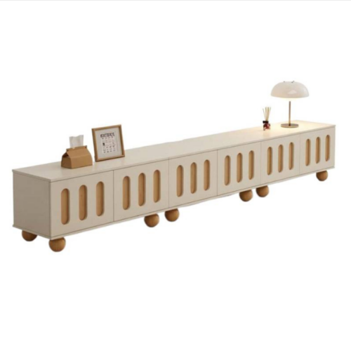 Long beige TV console with wooden legs and oval cutouts.